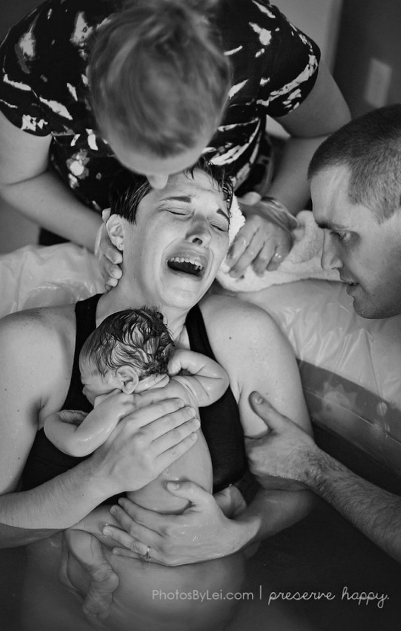 This baby was just born into her mother's arms in the water. She is povercome with joy.